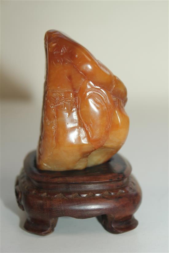 A Chinese Tianhuang stone landscape carving, 136g., 7 x 4 x 3.5cm, wood stand